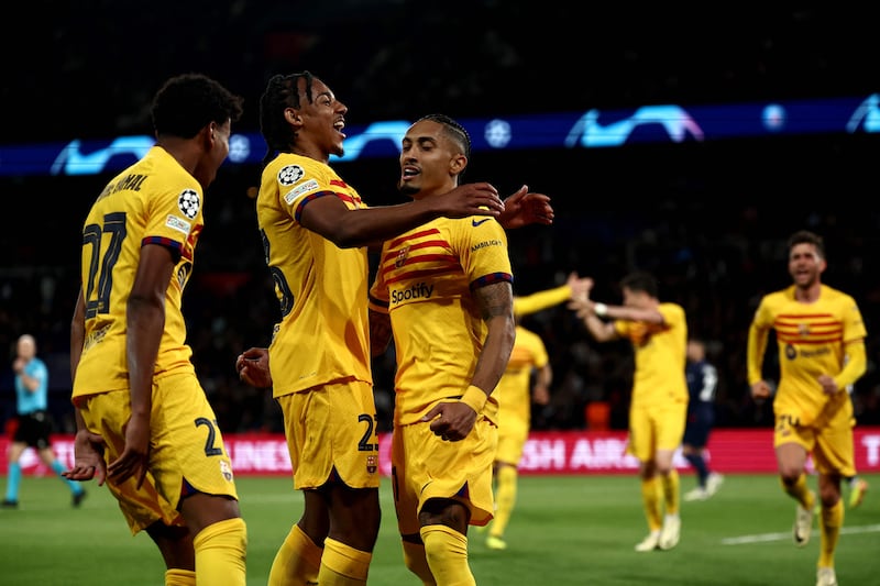 Barcelona players celebrate with Raphinha after he scored the opening goal against PSG. AFP