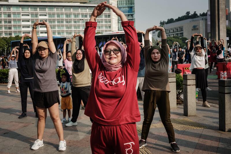 People attend a morning dance session on the street during a car-free day in Jakarta. AFP