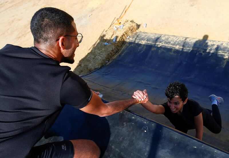 Teamwork is key in the Egypt's Tough Mudder challenge, say organisers, as these competitors demonstrate. Reuters