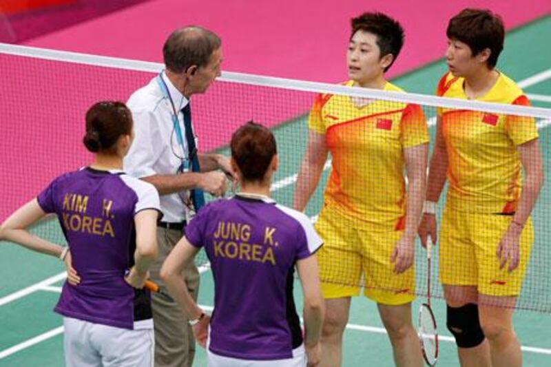 An official speaks to players from China and South Korea during their controversial women's doubles match at London 2012