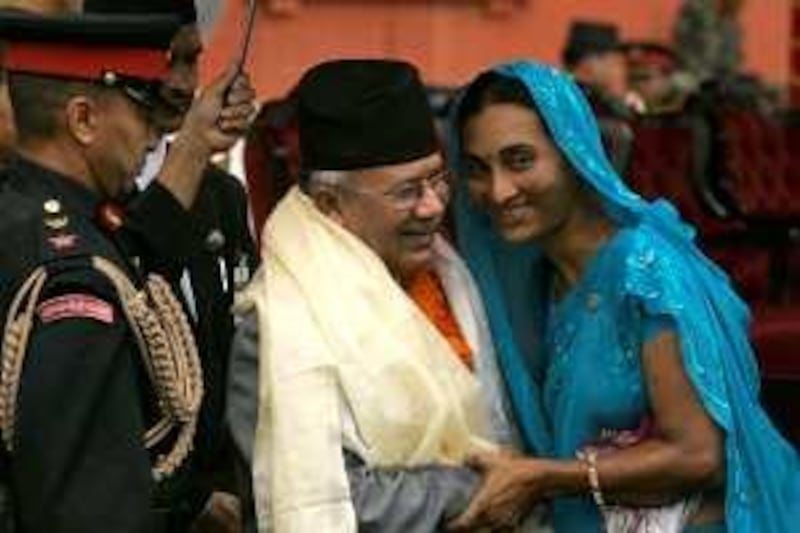 A well wisher hugs Nepal's new Prime Minister Madhav Kumar Nepal, center, in Katmandu, Nepal, Monday, May 25, 2009. Nepal was sworn in Monday as the country's prime minister and immediately took up the task of governing without the support of the Himalayan nation's biggest party. (AP Photo/Gemunu Amarasinghe) *** Local Caption ***  GAX105_Nepal_Politics.jpg