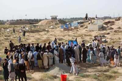 Mourners attend the burial ceremony of Kunduz police spokesman Sayed Sarwar Hussaini, who was killed by a suicide bomber while he was speaking to reporters, in Kunduz on September 1, 2019. Afghan security forces appeared to have cleared Kunduz of Taliban fighters on September 1, a day after insurgents tried to repeat a 2015 takeover of the northern Afghanistan city. / AFP / STR
