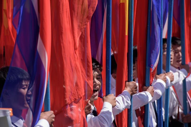 Students march past a balcony from where North Korea's leader Kim Jong Un was watching, during a mass rally on Kim Il Sung square in Pyongyang.  AFP