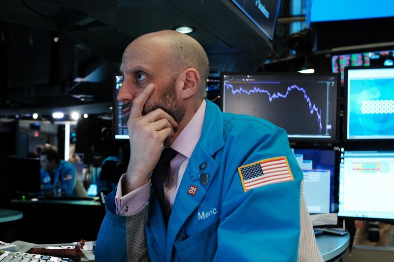 Traders work on the floor of the New York Stock Exchange (NYSE) in New York City. AFP