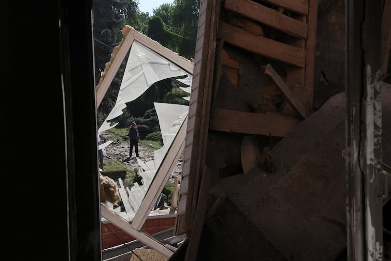 An onlooker takes in the damage from overnight shelling on Kharkiv's Housing and Communal College. Reuters