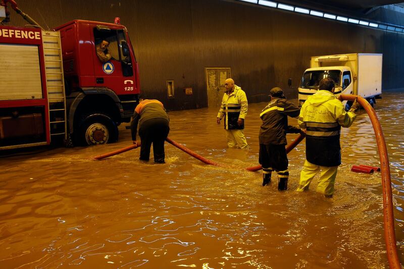 Civil Defense workers pump water out of a tunnel in Beirut's southern suburb of Ouzai. AP Photo