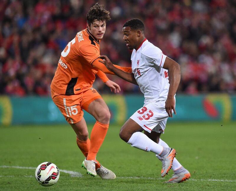 Brisbane Roar player Devante Clut competes with Liverpool's Jordon Ibe for the ball during Friday's friendly match in Brisbane. Dave Hunt / EPA