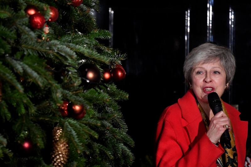 Britain's Prime Minister, Theresa May, uses a microphone  during the ceremony of switching on the lights of the Christmas tree in Downing Street, in central London, Britain December 6, 2018.  REUTERS/ Toby Melville