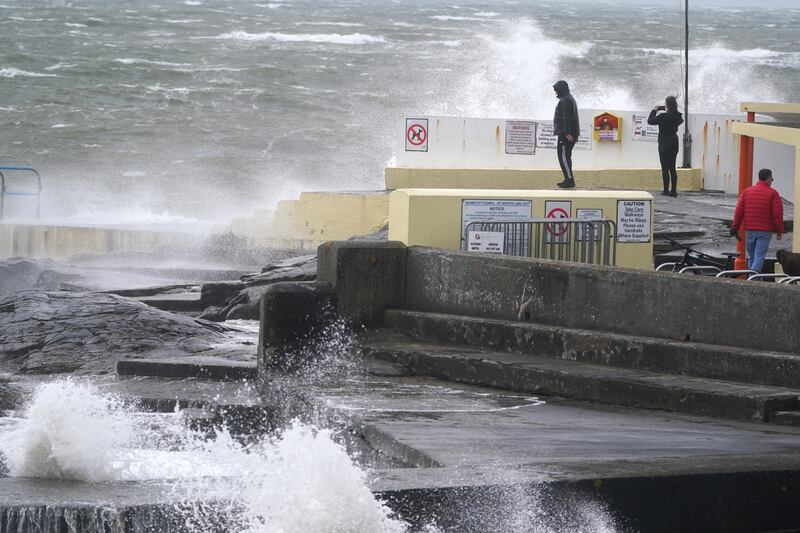 People look at the the waves at Blackrock Diving Board. PA