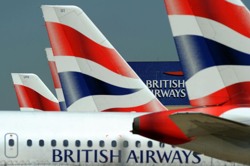 (FILES) In this file photo taken on May 24, 2010 shows the British Airways logo between tailfins of aircraft parked at Heathrow Airport, west of London.  British Airways on February 28, 2019 announced a multi-billion dollar deal to buy up to 42 Boeing 777 fuel-efficient passenger jets, after Airbus said it would no longer make the A380 superjumbo. / AFP / FILES / Adrian DENNIS
