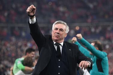 Real Madrid's Italian coach Carlo Ancelotti gestures as he celebrates his team's victory during the UEFA Champions League final football match between Liverpool and Real Madrid at the Stade de France in Saint-Denis, north of Paris, on May 28, 2022.  (Photo by Anne-Christine POUJOULAT  /  AFP)