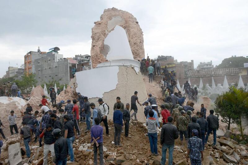 Nepalese rescue members and onlookers gather at the collapsed Darahara Tower in Kathmandu. Prakash Mathema / AFP