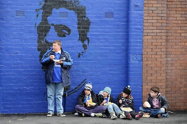 Children eat fish and chips before a football match at a park in Liverpool, England, October 19, 2013. Getty