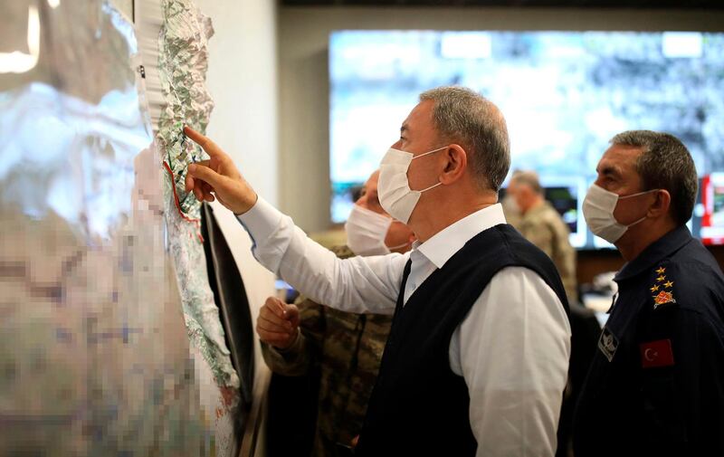 A  handout image made available by the Turkish Ministry of Defense Press Office on June 17, 2020, shows the Turkish Minister of Defense Hulusi Akar  looking at a map with members of the Turkish Armed Forces Command during a meeting at the Army Command Control Center in Ankara during the military operation dubbed "Claw-Tiger" on June 17, 2020. Turkey launched an air and ground offensive against Kurdish rebels in northern Iraq on June 17, 2020, in a move likely to increase friction with the Baghdad government. The operation, dubbed "Claw-Tiger", came after a "recent upsurge in attacks on our police stations and military bases" near the Iraqi border. - RESTRICTED TO EDITORIAL USE - MANDATORY CREDIT "AFP PHOTO /Turkish Ministry of Defense Press Office " - NO MARKETING - NO ADVERTISING CAMPAIGNS - DISTRIBUTED AS A SERVICE TO CLIENTS
 / AFP / TURKISH DEFENCE MINISTRY / handout / RESTRICTED TO EDITORIAL USE - MANDATORY CREDIT "AFP PHOTO /Turkish Ministry of Defense Press Office " - NO MARKETING - NO ADVERTISING CAMPAIGNS - DISTRIBUTED AS A SERVICE TO CLIENTS
