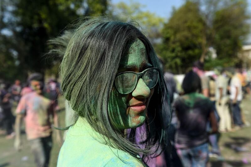 A student from Lalbhai Dalpatbhai (LD) College of Engineering with her face covered with coloured powder celebrates 'Holi', the Hindu spring festival, with eco-friendly coloured powders in Ahmedabad on March 7, 2020. AFP