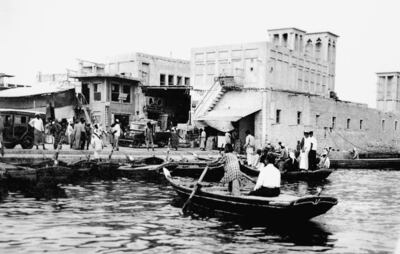 Fishermen dock in Dubai harbour in this picture dated 1960, which shows the traditional architecture in the area. WAM / AFP