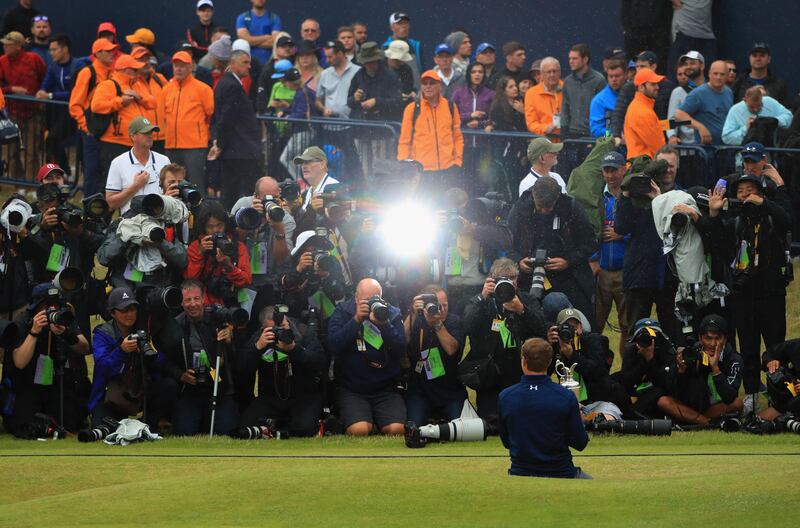Jordan Spieth of the United States celebrates victory as he poses in front of photographers with the Claret Jug on the 18th green during the final round of the 146th Open Championship at Royal Birkdale on July 23, 2017 in Southport, England. Andrew Redington / Getty Images