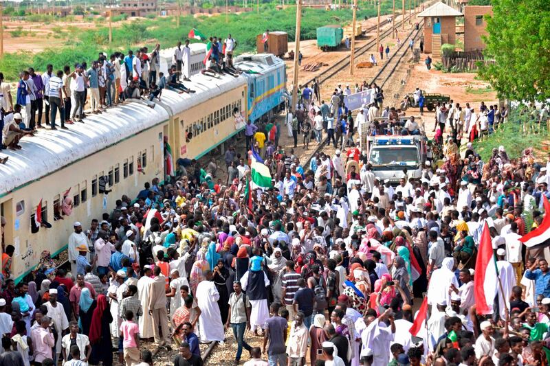 Sudanese protesters from the city of Atbara arrive at the Bahari station in Khartoum, to celebrate transition to civilian rule.  AFP