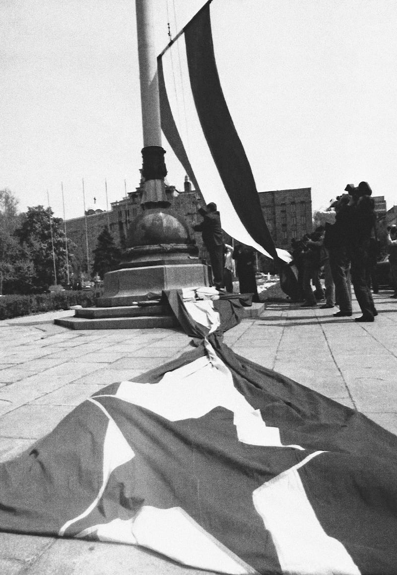 The old Yugoslav flag, with the Socialist red star symbol, is removed as the new one without the red star is flown on Monday, April 27, 1992 in Belgrade after the proclamation of the constitution in New Yugoslavia. The new state was announced as the unification of Serbia and Montenegro, despite western threats that the new state could lose diplomatic recognition and UN membership as the old Yugoslavia. AP