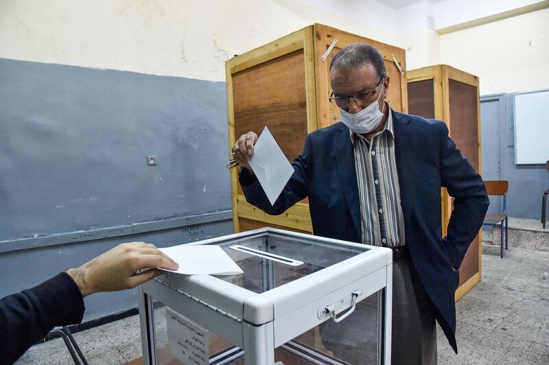An Algerian man casts his ballot at a polling station in the capital Algiers. AFP