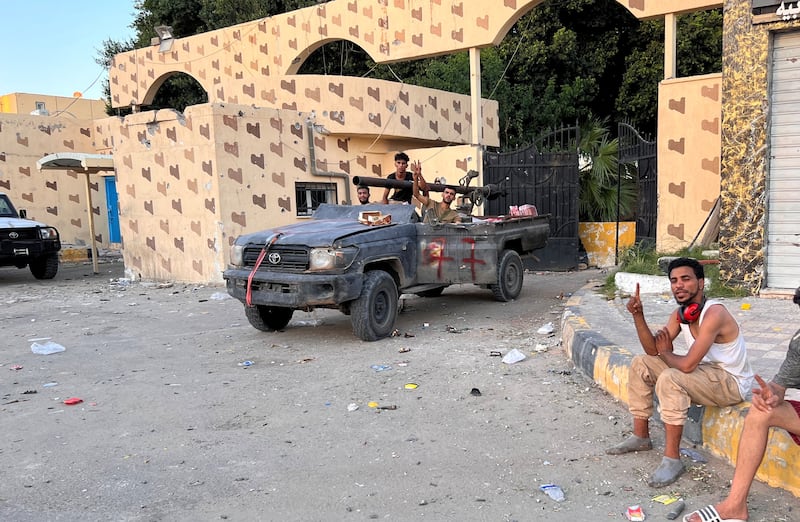 Fighters loyal to the head of Libya's Government of National Unity gather in the street. Reuters