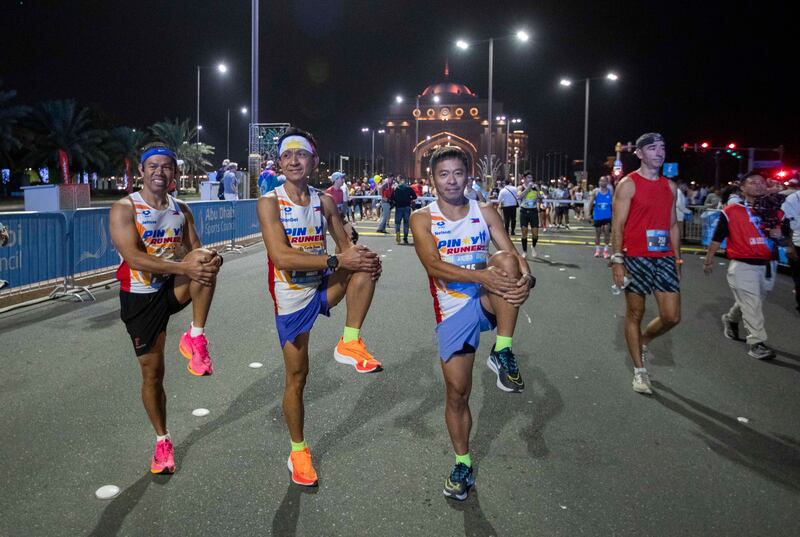 Participants warm up for the Adnoc Abu Dhabi Marathon