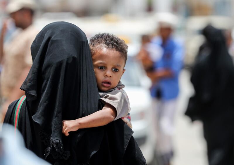 A Yemeni woman carrying a child to a hospital in the southeastern port city of Mukalla. AFP