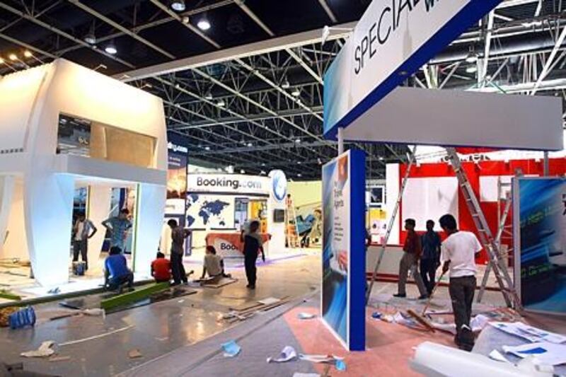 Dubai, United Arab Emirates- May,04,  2013:  Exhibitors busy setting up their Stands for the Arabian  Travel Market which will commence  on  6th May 2013 at the Dubai International Exhibition Centre in Dubai.  (  Satish Kumar / The National ) For Business