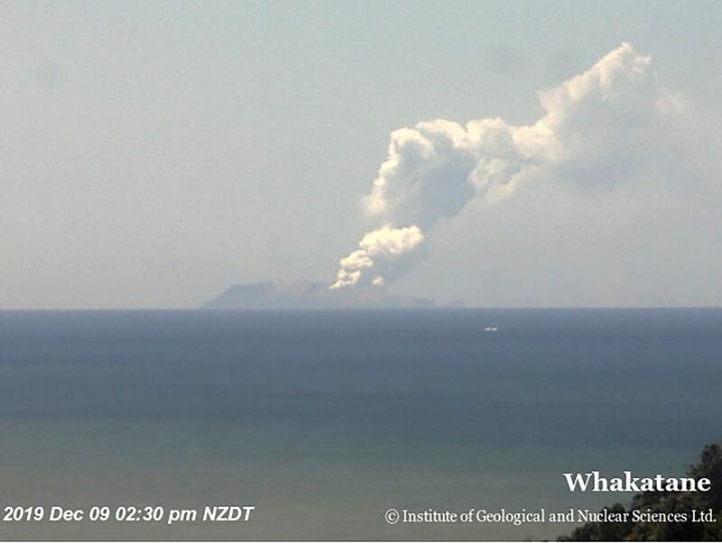 Plumes of smoke from a volcanic eruption on White Island, seen from Whakatane, New Zealand. GNS Science via AP