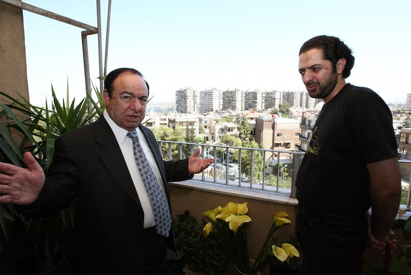 Sabah Fakhri with his son Anas Abu Qos during an interview in Damascus on July 25, 2008. AFP