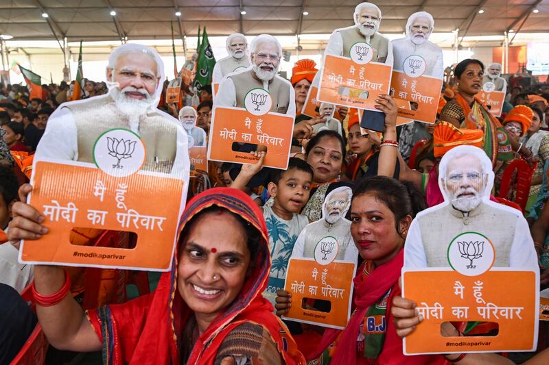 Supporters of Bharatiya Janata Party (BJP) hold cut-outs of India's Prime Minister Narendra Modi during an election campaign rally in New Delhi in May ahead of the final voting rounds on May 20, May 25 and June1.  (Photo by Arun SANKAR  /  AFP)