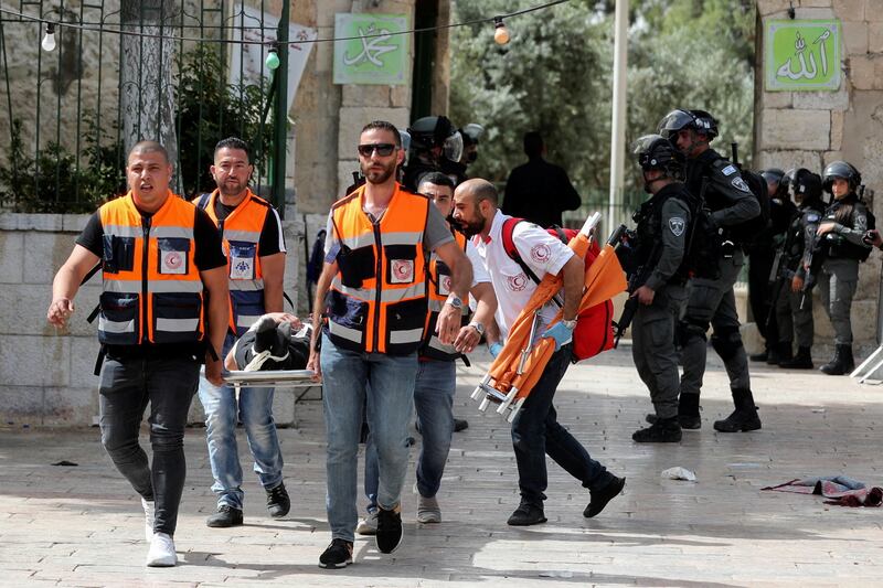 A wounded Palestinian is carried during clashes with Israeli police at the compound that houses Al Aqsa Mosque. Reuters
