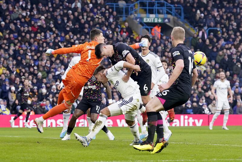 Leeds goalkeeper Illan Meslier punches the ball clear. PA