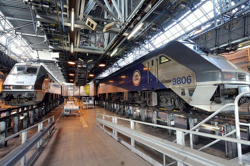 Eurotunnel trains in a hangar for maintenance in Coquelles, northern France. Up to 400 trains pass through the tunnel each day, carrying an average of 50,000 passengers, 6,000 cars, 180 coaches and 54,000 tonnes of freight. Denis Charlet / AFP