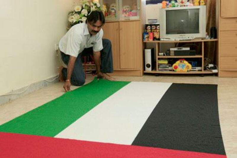 ABU DHABI, UNITED ARAB EMIRATES - April 6, 2009: Jeyaraman Ravi displays his beaded United Arab Emirates flag which he built alone over 14 months. He is in the process of having it recognized by the Guiness Book of World Records as the largest individual hand made bead flag. 

( Ryan Carter / The National )