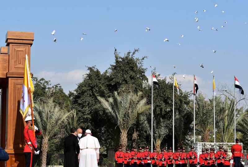 Pope Francis is welcomed by Iraqi President Barham Salih at the Presidential Palace. AFP