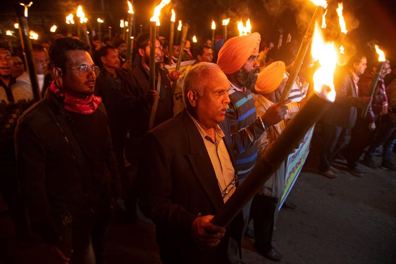 Indian protestors march in a torch light procession against the Citizenship Amendment act in Gauhati, India. AP