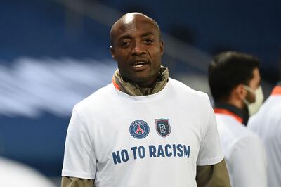 TOPSHOT - Istanbul Basaksehir's Cameroonian assistant coach Pierre Webo, wearing a tshirt reading "No to racism", looks on during warm-up before the UEFA Champions League group H football match between Paris Saint-Germain (PSG) and Istanbul Basaksehir FK at the Parc des Princes stadium in Paris, on December 9, 2020. The group game in Paris, which was goalless at the time, was suspended when both teams left the pitch on December 8, 2020 after a touchline argument erupted when the Romanian fourth official, Sebastian Coltescu, appeared to describe Basaksehir assistant coach Pierre Webo, a former Cameroon international player, as "black", or "negru" in Romanian and will resume on December 9 where it left off, in the 14th minute, with a different set of officials.
 / AFP / FRANCK FIFE
