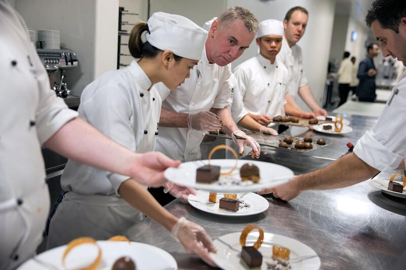 ABU DHABI, UNITED ARAB EMIRATES, Feb. 19, 2014:   
(C) Chef Gary Rhodes plates his decadent chocolate and coffee desert as he works alongside other chefs preparing a 4-course dinner for 320 guests at the Gourmet Abu Dhabi Awards Gala on Wednesday, Feb. 19, 2014, at the St. Regis Abu Dhabi hotel in Nation's Towers on Corniche in Abu Dhabi.  (Silvia Razgova / The National)

Reporter: Stacie Overton Johnson
Section: Arts&Life
Usage: Feb. 21, 2014

