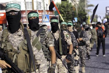 Masked militants from the Qassam Brigades, a military wing of Hamas, march with their rifles during a parade along the streets of Gaza City, Tuesday, July 25, 2017. AP