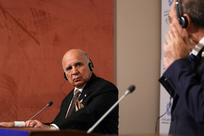 Iraqi Foreign Minister Fuad Hussein, left, and Jordanian counterpart Mr Safadi take part in a news conference. Reuters