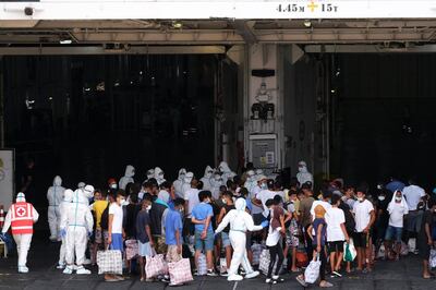 TOPSHOT - Migrants board the 'MS GNV Azzurra' quarantine ship which has has been sent on the Italian Pelagie Island of Lampedusa on August 4, 2020, amid the COVID-19 (novel coronavirus) pandemic. The interior ministry has acknowledged that the economic crisis caused by COVID-19 in Tunisia has fed an "exceptional flow of economic migrants" to Italy's borders, while the virus has made managing numerous daily arrivals more complex. / AFP / Dario PIGNATELLI
