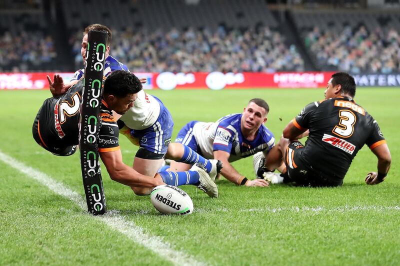 David Nofoaluma scores a try as he is tackled by Kieran Foran during the NRL match between the Canterbury Bulldogs and the Wests Tigers at Bankwest Stadium in Sydney, Australia. Getty Images