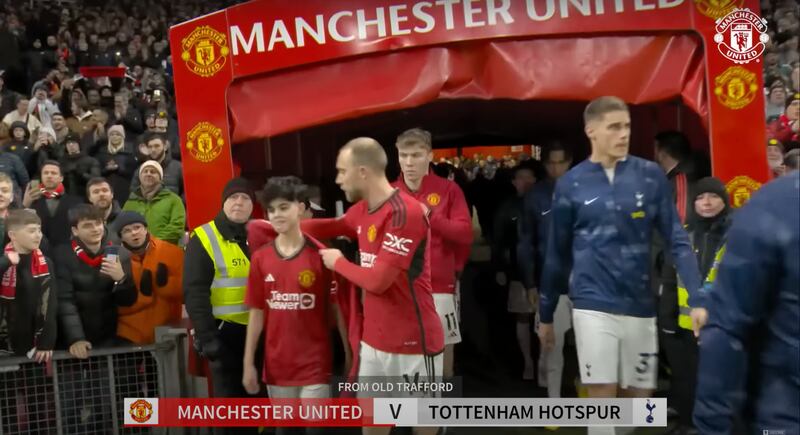 Christian Eriksen gives Dubai teenager Cameron Dean his jacket before their match against Tottenham on Sunday at Old Trafford. Photo: YouTube / Manchester United