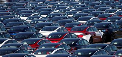 (FILES) In this file photo taken on April 20, 2020 newly manufactured Tesla electric cars are pictured in a storage area at The Western Docks in Southampton, as life in Britain continues during the nationwide lockdown to combat the novel coronavirus pandemic. Tesla Motors reported its first annual profit January 27, 2021, but shares fell after Elon Musk's electric car company scored lower-than-expected fourth quarter earnings. / AFP / ADRIAN DENNIS
