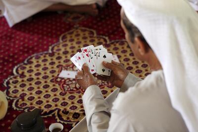 Ras Al Khaimah, United Arab Emirates - Reporter: Anna Zacharias: Race camel owner Saeed Salem Al Bathara plays cards. A Dutch poet scholar Marcel Kurpershoek (not in pic) visits Ras Al Khaimah in search of missing words used in the works of 17th century Ras Al Khaimah poet Ibn Dhaher, a renowned bard and folk hero. Sunday, March 1st, 2020. Ras Al Khaimah. Chris Whiteoak / The National