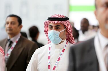 A delegate wears a face mask at the Arab Health event in Dubai on Wednesday. The N95 mask (not pictured) is more tightly fitted and offers greater protection - but doctors say no mask can completely prevent the spread of an airborne disease. Pawan Singh / The National 