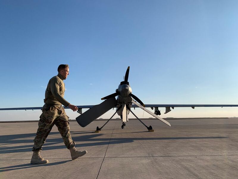 A US soldier walks past a drone in the Ain Al Asad airbase in the western Iraqi province of Anbar. AFP