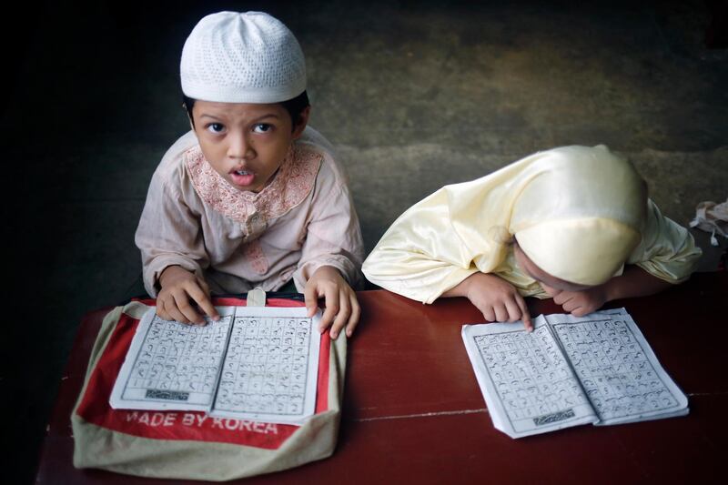 Bangladeshi Muslim children read the holy Koran at the Madrasa during the holy month of Ramadan in Dhaka. EPA