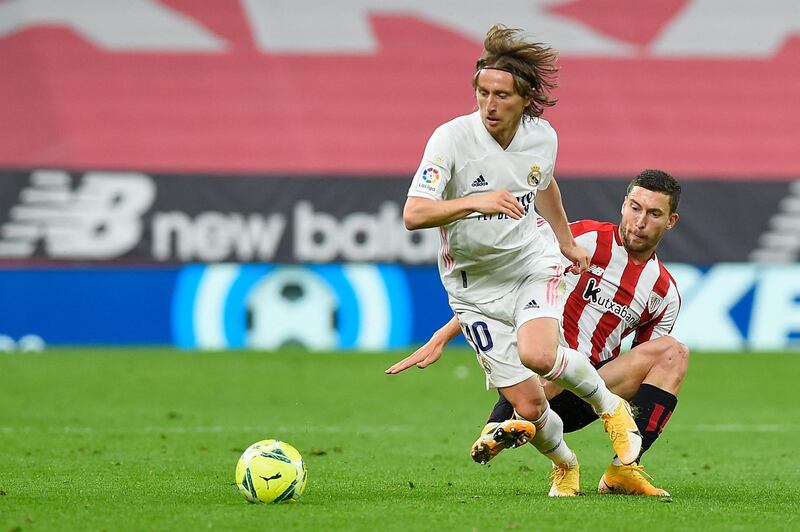 Real Madrid midfielder Luka Modric is tackled by Athletic Bilbao's Oscar De Marcos. AFP